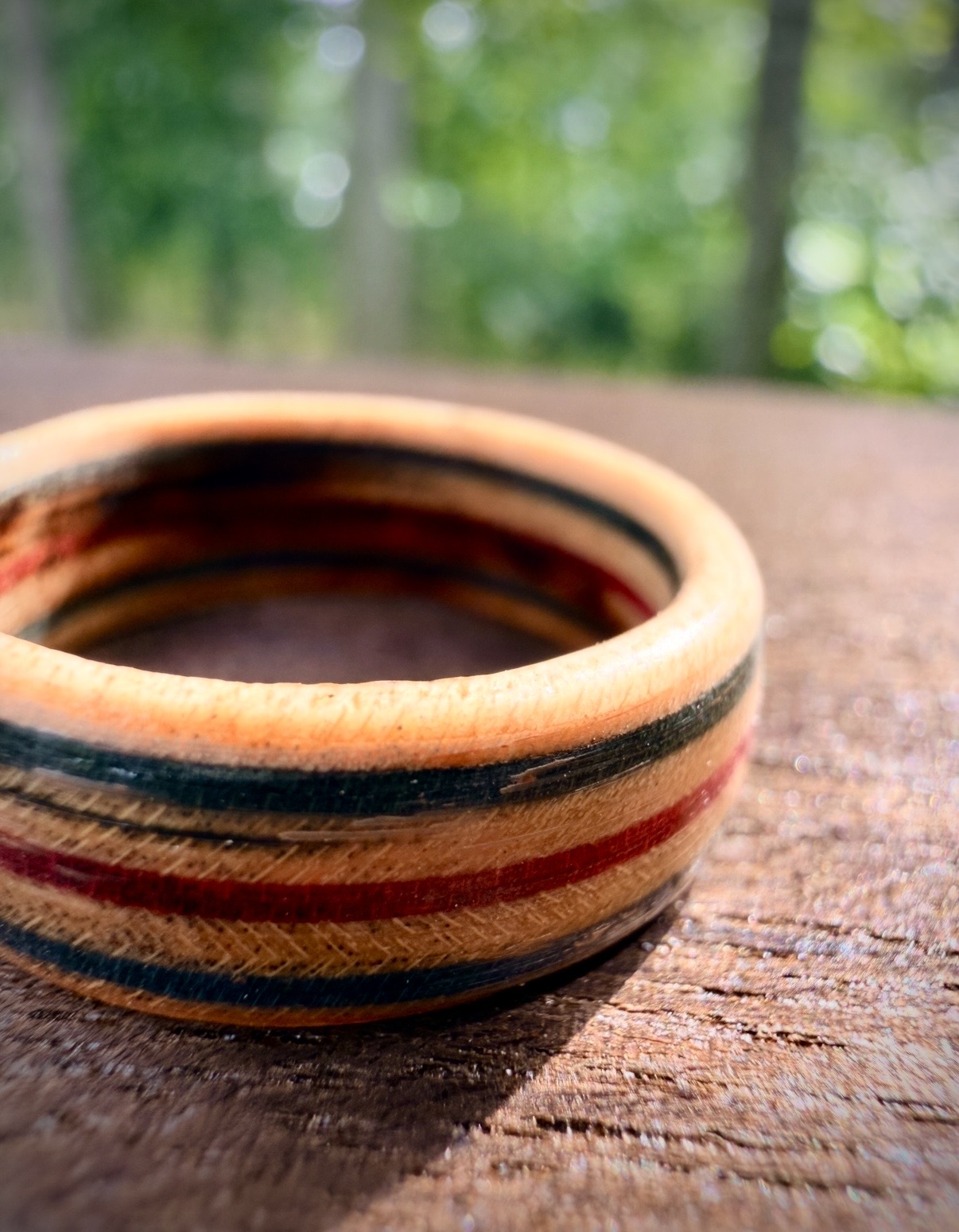 Striped wooden ring photographed outdoors